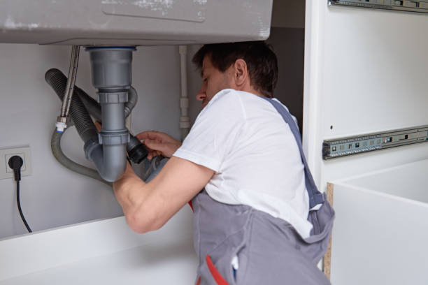 Plumber repairing kitchen sink plumbing